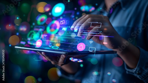 Close-up of hands typing on a digital tablet with a holographic virtual projection of data above the display