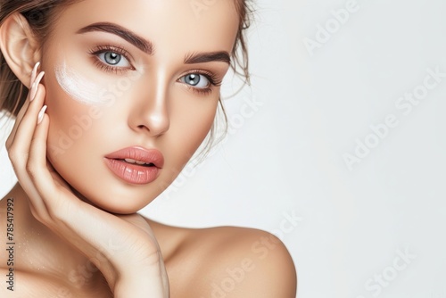 Youthful Woman Showcasing Clean and Fresh Skin Care Routine with a Gentle Touch on her Face. Concept of Cosmetology and Beauty Spa for Radiant Skin Glow.