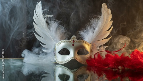angel feather mask white and red ; red and white smokes around the mask on a glass background  photo
