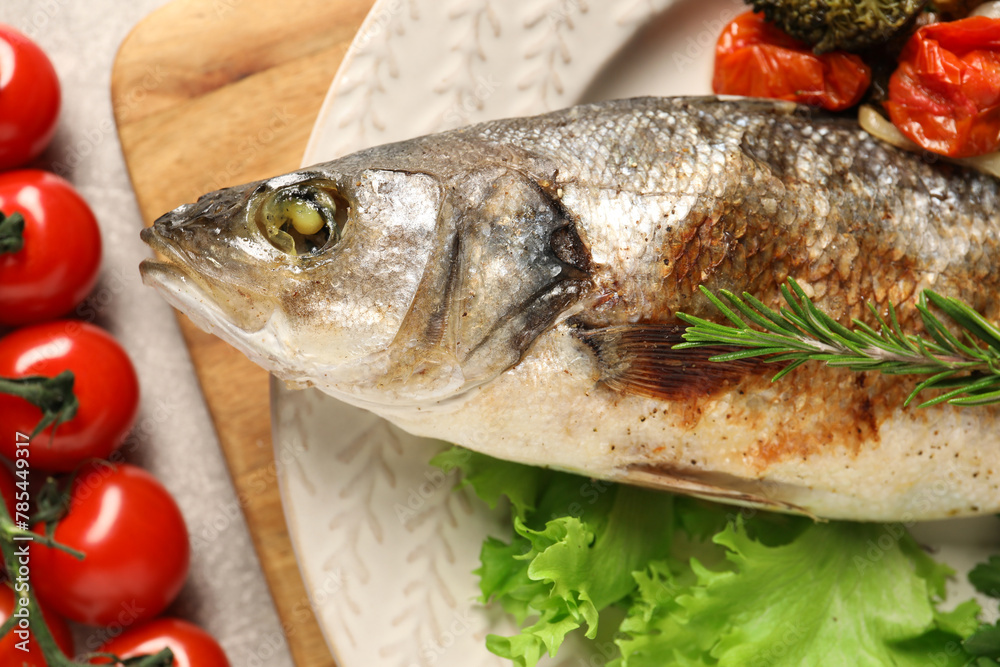 Delicious baked fish and vegetables on table, top view Delicious baked fish and vegetables on table, top view