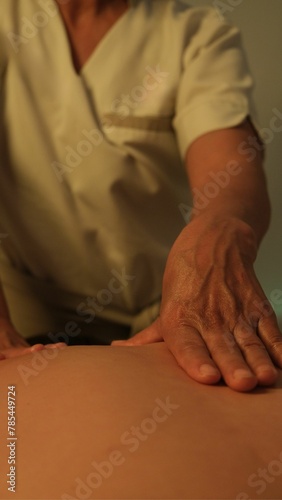 Masseuse doing back massage. close up of a person receiving a massage