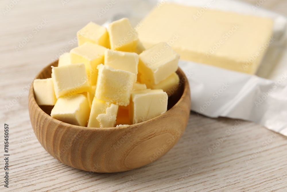 Tasty butter on light wooden table, closeup Tasty butter on light wooden table, closeup