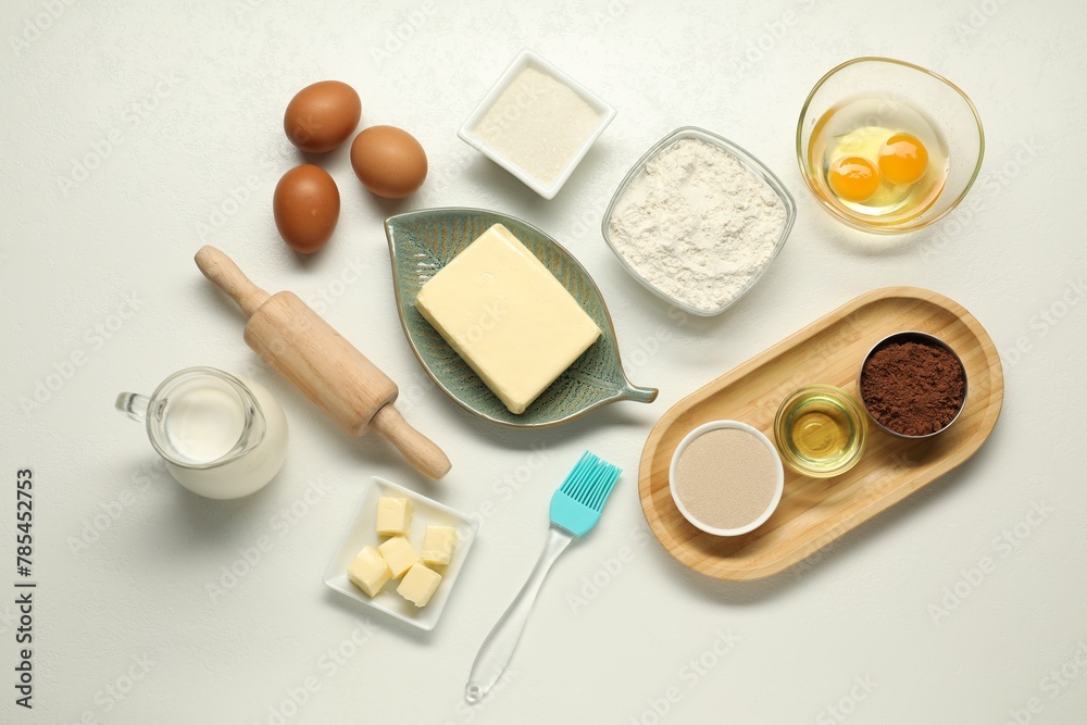 Flat lay composition with fresh butter among other products on white table