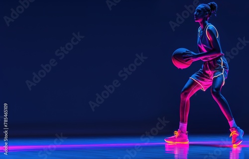 Basketball player glowing with neon lights on court.