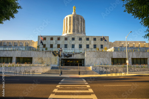 Oregon State Capitol in Salem with a clear blue sky. It is distinguished by its Art Deco architecture and the Oregon Pioneer statue atop its dome. photo