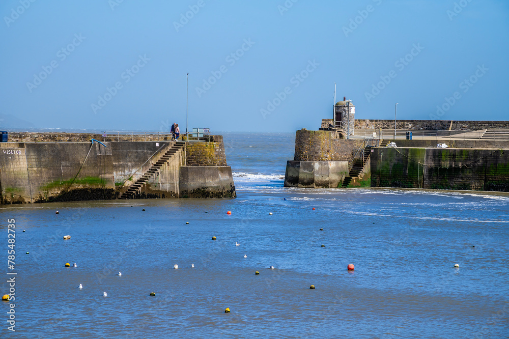 A view towards the harbour entrance at low tide in Saundersfoot, Wales on a bright spring day A view towards the harbour entrance at low tide in Saundersfoot, Wales on a bright spring day