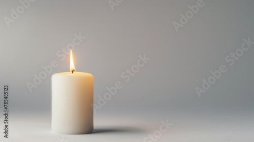 White candle on bright background with a free place for text. Concept of home, spa, relaxation, meditation or festive celebration banner.
