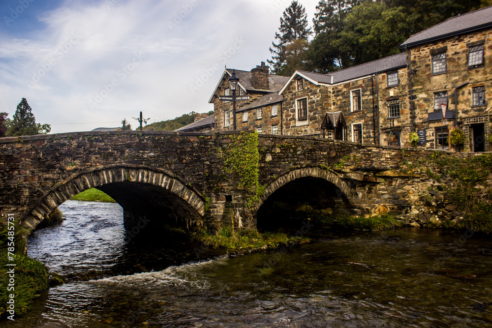 The Double arched stone bridge crossing the River Colwyn in the small picturesque town of Beddgelert in Eryri National Park, Wales