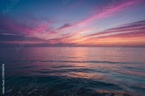 sunset with glowing pink and purple horizon on calm ocean seascape background