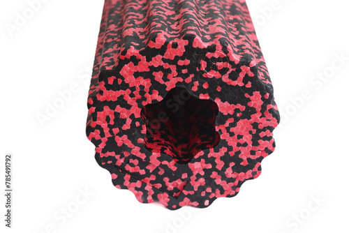 A black red massage foam roller isolated on a white background. Close-up. Foam rolling is a self myofascial release technique. Concept of fitness equipment.