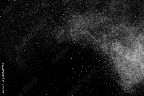 Black and white grunge texture background. Abstract splashes of water on dark backdrop. Light clouds overlay.