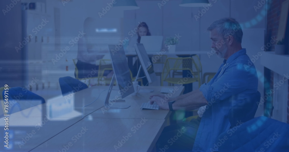 Image of stock market data processing against caucasian man using computer at office Image of stock market data processing against caucasian man using computer at office