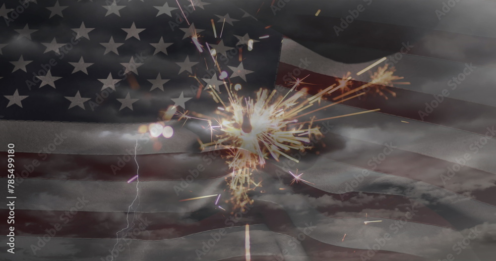 Fototapeta premium Image of glowing sparkler and clouds on sky over american flag