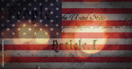 Image of out of focus glowing sparkles and american constitution text over american flag