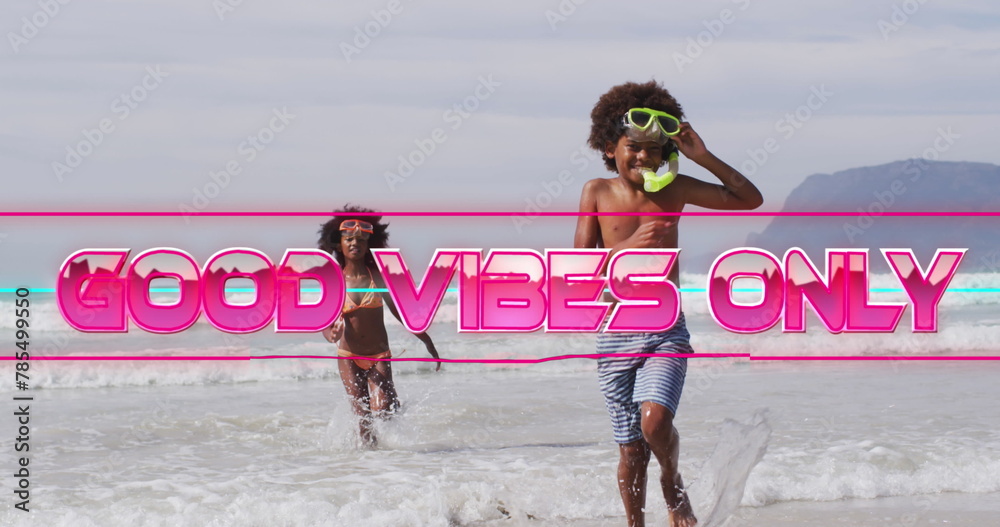 Fototapeta premium Image of good vibes only text with african american children at beach