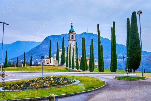 Flowerbed and Sant'Abbondio Chuch on background, Collina d'Oro, Switzerland photo