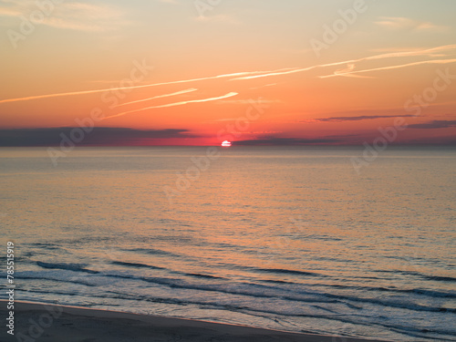 Orange sunrise with clear skies over the Ocean