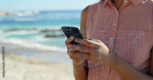 Image of qr code, digital lines with skyscrapers over caucasian woman using phone at beach