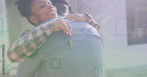 Image of pattern over african american couple with house keys