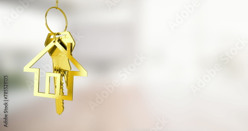 Image of gold house key fob and key dangling over out of focus interiors with copy space