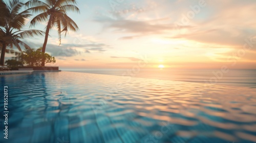 Blurred view of a luxurious hotel pool overlooking a paradisiacal beach at sunset with no one in the image 04 photo