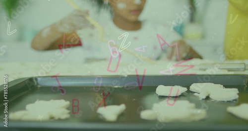 Image of letters and numbers falling over african american girl making cookies