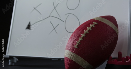 Image of lens flare, abstract pattern over rugby ball, water sipper and game plan on white board
