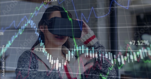 Image of financial data processing over caucasian woman using vr headset