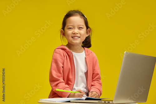  Cheerful Korean Toy with Bright Smile Engages in Learning sitting over isolated background. Sprightly Chinese Child Enjoys Study Time