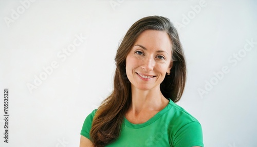 Portrait of happy mature woman in bright vivid green dress smiling to the camera isolated on white background with copy space