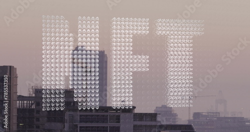 Image of white particles forming a nft text banner against aerial view of cityscape