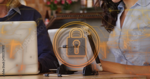 Image of security padlock and light trails over biracial woman using digital tablet at a bar