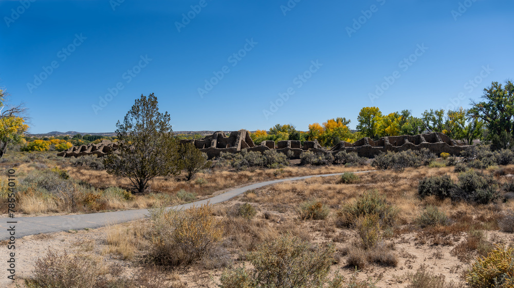 Aztec Ruins National Monument in New Mexico. Best preserved Chacoan structures including Aztec West great house built by ancestral Pueblo people. 400 rooms and three stories, autumn cottonwood trees.