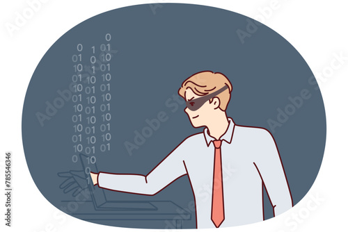 Man hacker in mask hiding face reaches out to laptop screen to steal important information or commit cybercrime. Guy hacker makes digital fraud and hacks computer via internet or local network