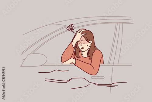 Woman driver was in car accident, crying sitting behind wheel in broken automobile and feeling dizzy due to hangover. Drunk girl caused car accident on highway because of lack knowledge traffic rules