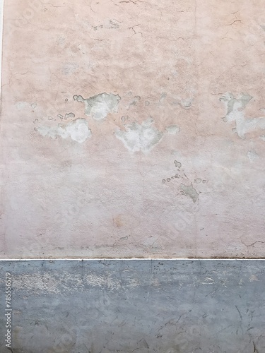 Cracked wall surface. Old building. Neutral pastel colour background
