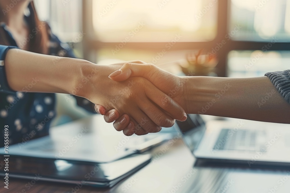 Two business people shaking hands over an office desk, closeup of handshakes and professional attire The concept symbolizes trust Generative AI Two business people shaking hands over an office desk, closeup of handshakes and professional attire The concept symbolizes trust Generative AI