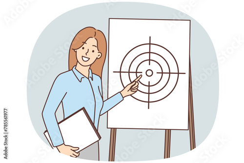 Young businesswoman point at target on flipchart