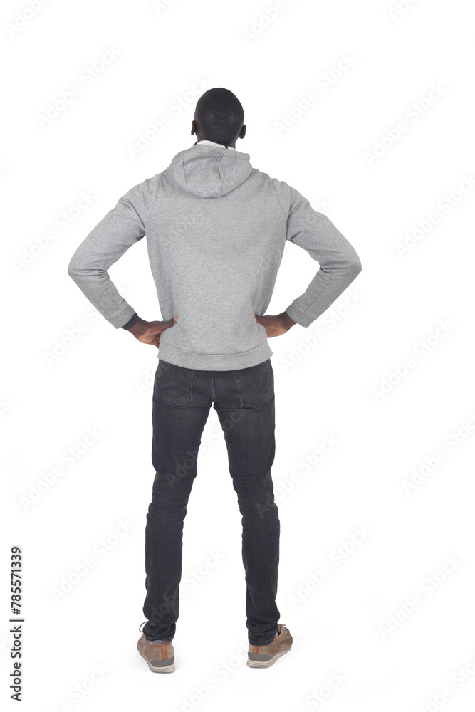 back view of a man standing , amrs akimbo and look up on white background