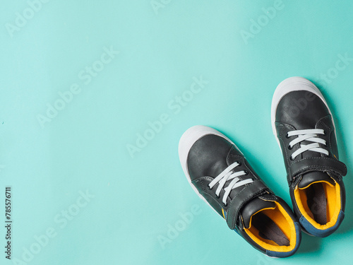 Gray and yellow sneakers on blue background