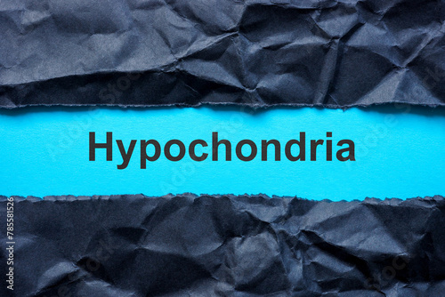 Torn black paper and word hypochondria. photo