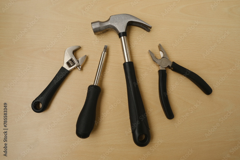 Profi hammer, mallet, Adjustable wrench, versatile tool for turning nuts, bolts, and other components, held by male craftsman's hand isolated, on light blue background Profi hammer, mallet, Adjustable wrench, versatile tool for turning nuts, bolts, and other components, held by male craftsman's hand isolated, on light blue background