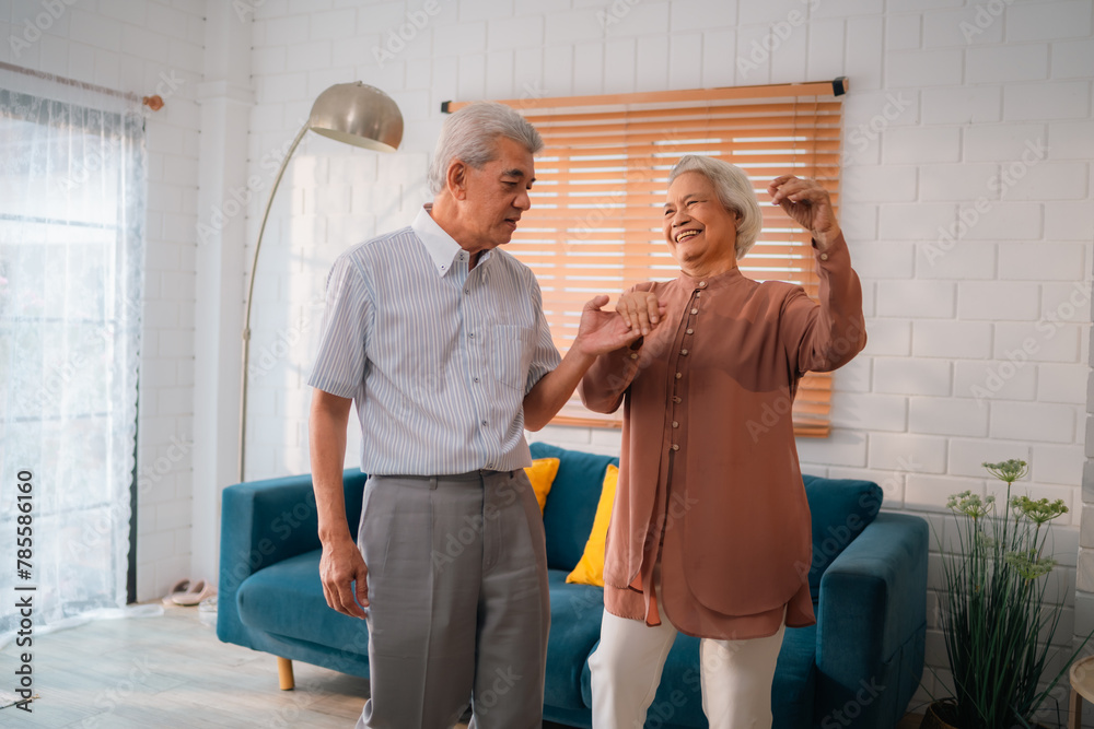 Obraz premium Elderly Romance in the 60s and 70s: Grandparents Sharing Laughter and Hugs on the Couch, Embracing the Joys of Retirement Together, A Heartwarming Indoor Scene of Mature Love and Relaxation