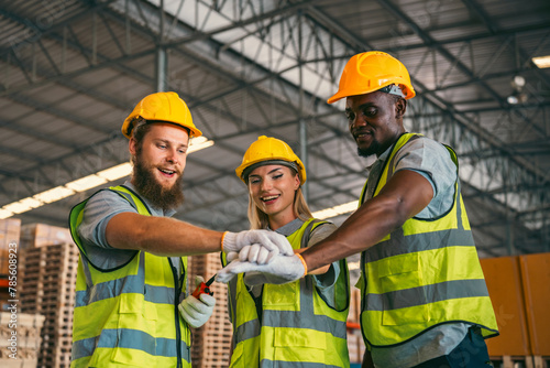 In a factory setting, a team of engineers and foremen emphasize safety and teamwork during a meeting, ensuring success in the construction industry.