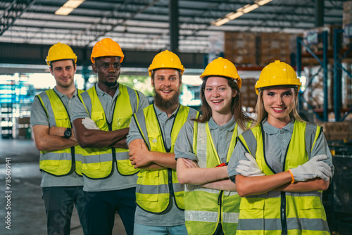 In a factory setting, a team of engineers and foremen emphasize safety and teamwork during a meeting, ensuring success in the construction industry.