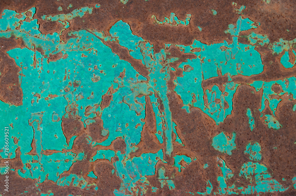 metal plate with green parts and others with rust forming abstract drawings