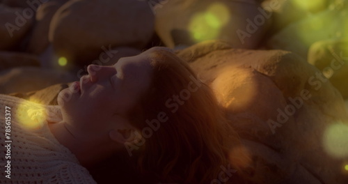 Image of stars over caucasian woman at beach