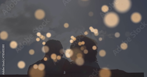 Image of light spots over african american couple at beach #785615380