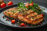 product photography of Grilled salmon with salad on a black plate against a dark background,