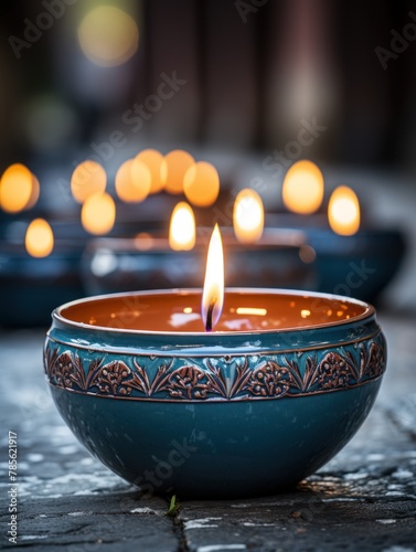 A blue bowl with a candle burning inside